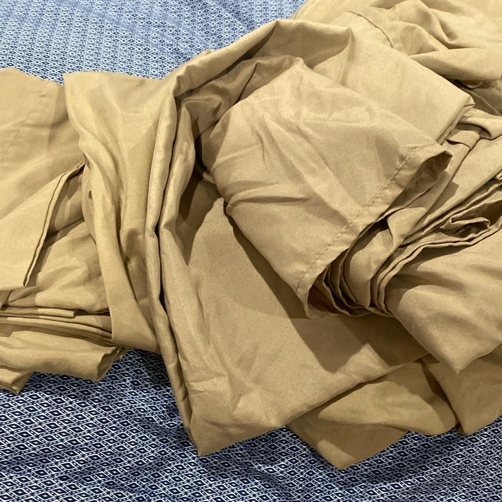 Queen size pillowcases flat, and fitted sheet in a gold color